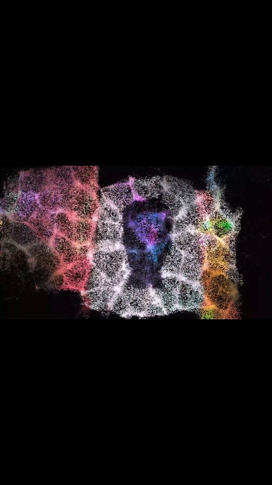 A pink and purple particle figure on black — digital art.