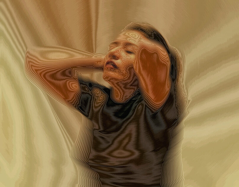 A figure resting on draped cream and tan fabric, an arm across the face — soft, muted, lived-in.